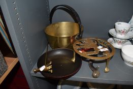 A selection of brass wares including rampant lion trivet, jam pan and sauce pan and a candle
