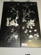 A pair of 20th century Japanese Ebonised wood panels with mother of pearl inlay design
