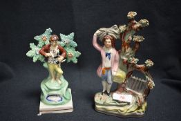 Two 19th century Staffordshire flatback figures of a man collecting hay and a boy with dog
