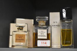 Two bottles of Chanel No.5 perfume with contents and a third empty bottle all having packaging