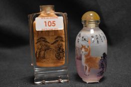 Two Chinese snuff bottles with hand painted decoration within glass bottle, one of two cats and a