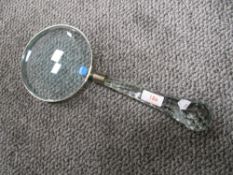 A modern over sized spy glass with clear cut crystal glass handle