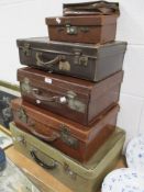 A selection of early 20th century and later leather bound briefcase or suitcase in vary sizes and