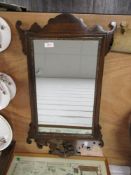 A 20th century Chippendale revival style mirror having shaped frame work with carved eagle