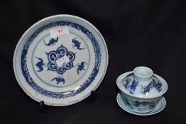 An early 19th century Japanese hard paste plate in blue and white design with a modern tea bowl
