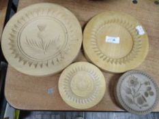 Four wooden butter moulds in traditional farmhouse pattern