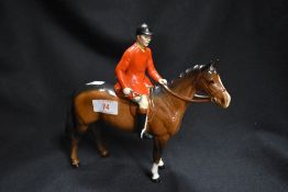 A Beswick figure of Huntsman on brown horse having minor chip to cap