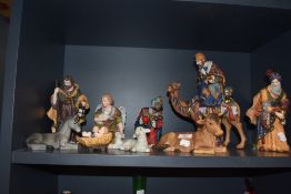 A 20th century ceramic nativity scene with three wise kings and a baby Jesus