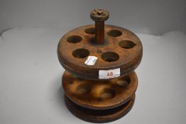 An early 20th century treen wood kitchen top egg holder