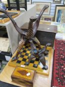 A selection of treen wood items including Indian table bases, chess board, money box and container
