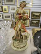 A mid century Italian style ceramic figure of a maiden feeding a goat