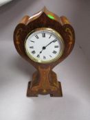 An early 20th century mahogany balloon clock having enamel face with Roman numerals and inlaid