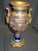 A Victorian mantel urn having ceramic cobalt and gilt decorated body with bronze gilt decorations