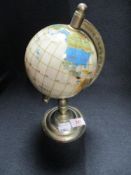 A desk top globe of small proportions.