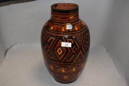 A Moroccan vase of Safi decoration with brown, yellow and black glaze