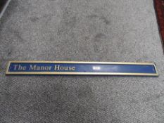 A composite house sign 'The Manor House'.