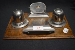 An Edwardian oak and chrome desktop stationary set with perpetual date calendar