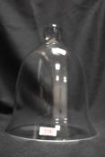 A modern hand blown glass dome with ball handle