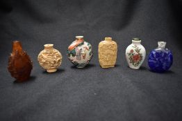 Six vintage Oriental carved snuff bottles, all with intricate detailing, incluing glass and