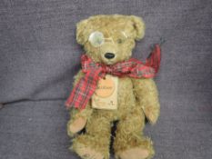 A Limited Edition Robin Rive bear, McKenzie 70/2000 with tags wearing glasses and tie
