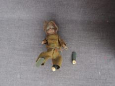 A vintage clockwork and wooden doll in traditional clothing (af)