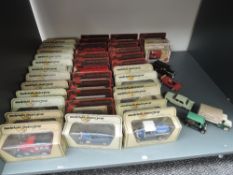 A shelf of Lledo and Matchbox Models of Yesteryear and similar diecasts, most in display boxes, app