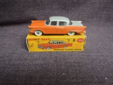 A Dinky diecast, 180 Packard Clipper Sedan, Orange & Grey, in original correct spot box