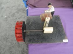 A wooden and metal working model, Water Wheel driving a Man turning Barrel, on cast metal plinth