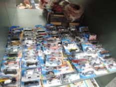 A shelf of modern Mattel Hotwheels diecasts, approx 90 all in blister packs, some opened