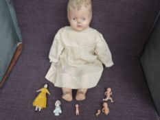A mid 20th century composition headed Doll having fixed open eyes and mouth, composition limbs and