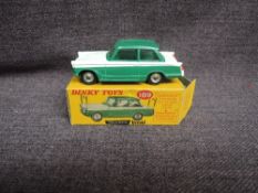 A Dinky diecast, 189 Triumph Herald, Green & White, in original correct spot box