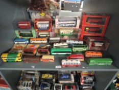 A shelf of Corgi Original Omnibus, EFE and similar diecast Buses along with similar Trams, boxed and