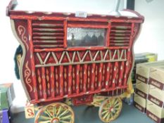 A hand made wooden model Gypsy Bow Top Caravan having hand painted decoration in the traditional