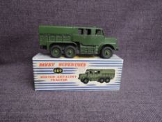 A Dinky diecast, 689 Medium Artillery Tractor in original blue and white striped box
