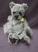 A Charlie Bears Jointed Teddy bear named Torquil having plastic eyes, stitched nose and mouth, two