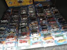 A shelf of modern Mattel Hotwheels diecasts, approx 63 all on bubble cars, some opened