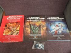 A TSR Dungeons & Dragons Basic Rules Set along with two TSR Advanced Dungeon Masters Guides