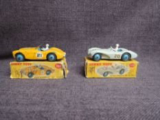Two Dinky diecasts, 109 Austin Healy 100 Sports, Yellow and blue hubs and 110 Aston Martin DB3, Grey