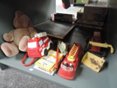 A shelf of vintage Toys including Triang Blackboard, Loading Shovel and plastic Fire Engine etc