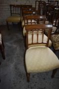 A set of six Edwardian mahogany dining chairs, the slightly bowed top rails with inlaid banding over