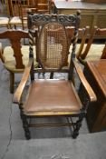 An early 20th century oak Carolean style armchair Seat height. 46CM.