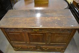 An century oak mule chest of traditional design with later carved frieze over three panels and two