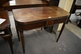A William IV Mahogany filled over tea table, with reeded edge detail inlaid tablet frieze and turned