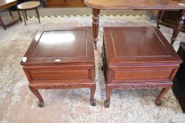 A pair of 20th century Chinese stained hardwood occasional tables or bedside tables, having carved