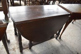 A 20th century reproduction oak gate leg table of traditional design. 74 CCM. X106CM. Sold with a