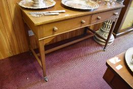 An Edwardian figured mahogany writing desk with banded rectangular top over two drawers and raised