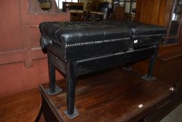 A 20th century ebonised wood double adjustable footstool, having deep buttoned leatherette