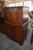 A reproduction mahogany bow fronted drinks cabinet with inset glass top. 125CM.