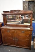 An Art Nouveau mahogany mirror back sideboard, with stipple carved scrolling foliate decoration.