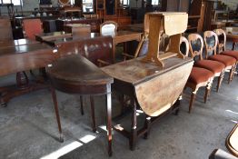 A 19th century oak drop leaf dining table of traditional design sold together with a 20th century